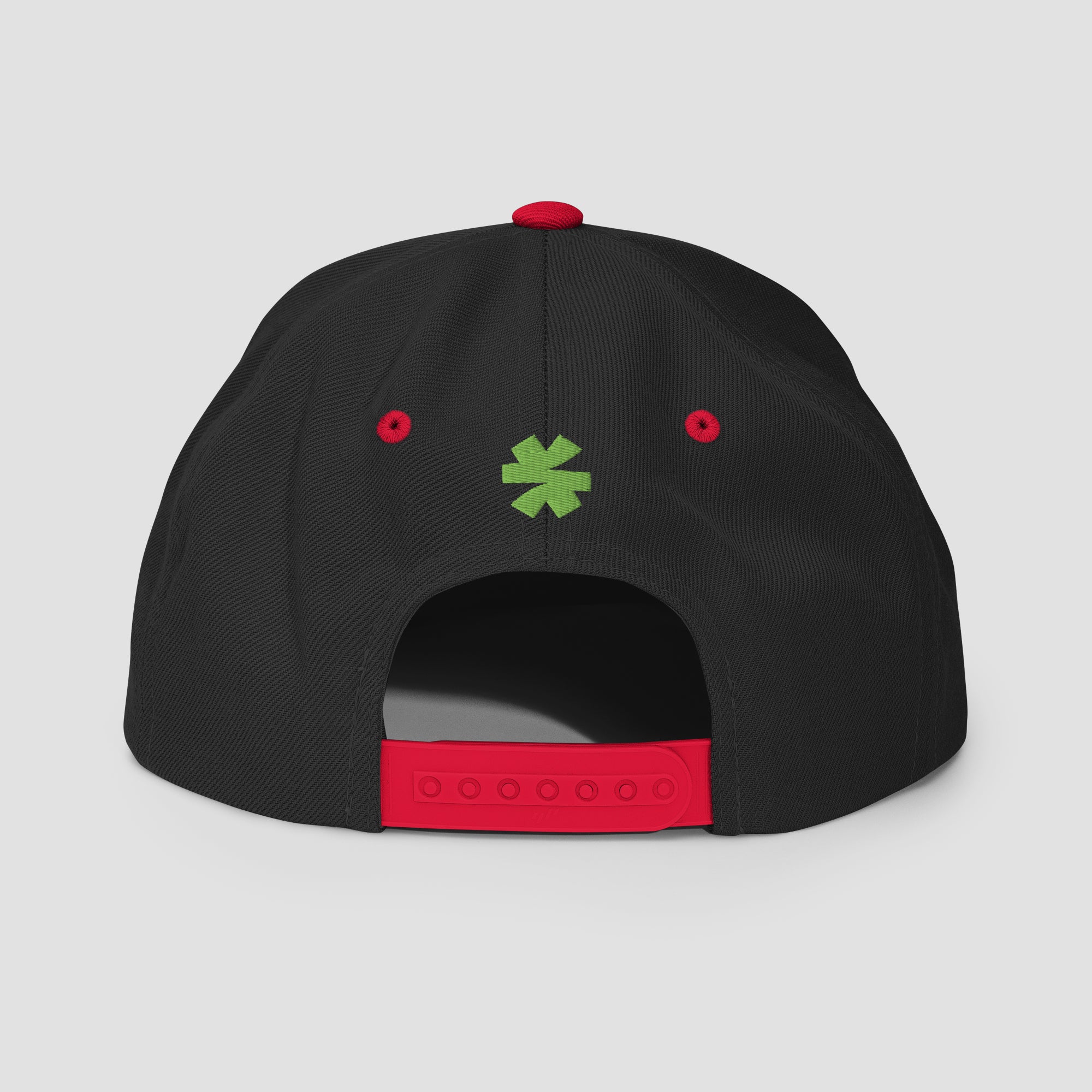 The back of a black snapback cap featuring a red adjustable strap, red eyelets, and a green asterisk in the center.