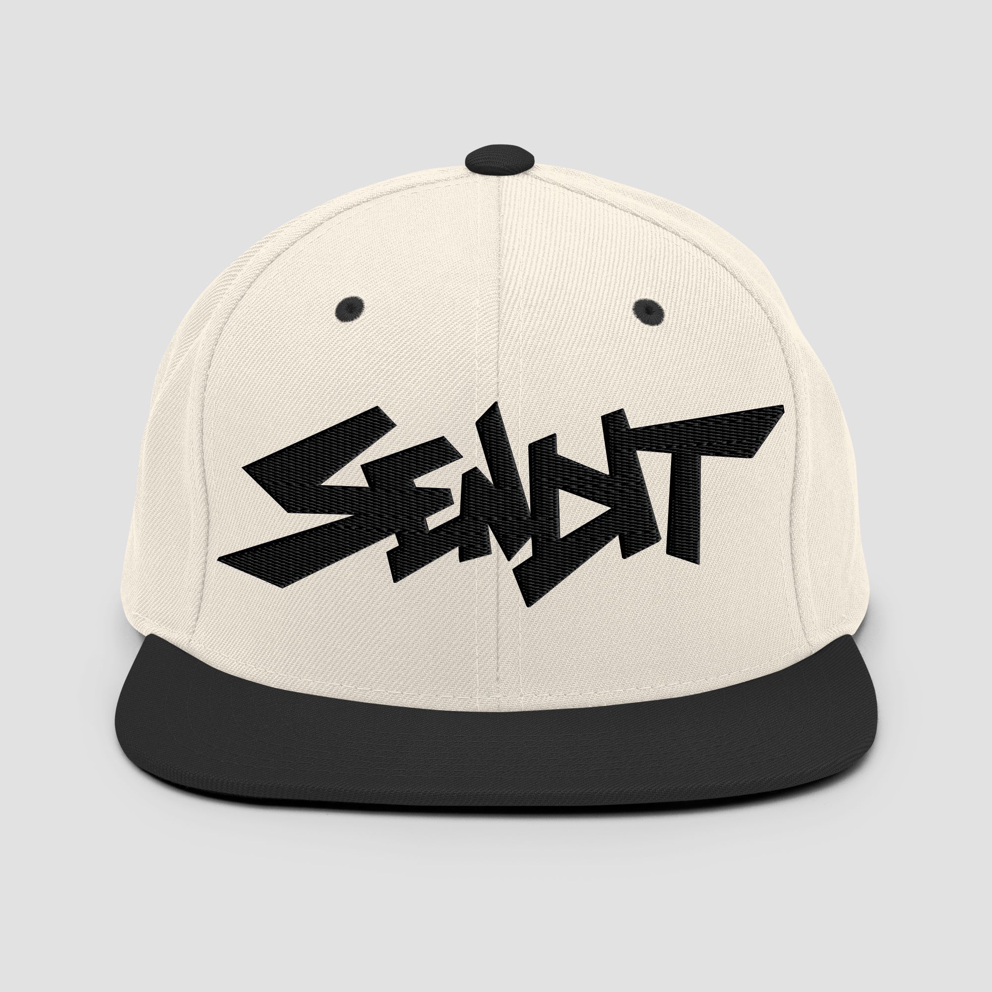 An off-white snapback cap with a black flat brim and a black embroidered stylized 'SENDIT' logo on the front, shown against a light gray background.