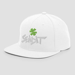 A white structured snapback cap with a flat brim, featuring a green embroidered asterisk above stylized white embroidery spelling 'SENDIT' on the front, set against a light gray background.