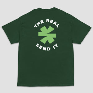 A dark green short-sleeve t-shirt shown from the back, featuring a green and black logo with the text 'THE REAL SEND IT' centered around a green asterisk set on a light gray background.