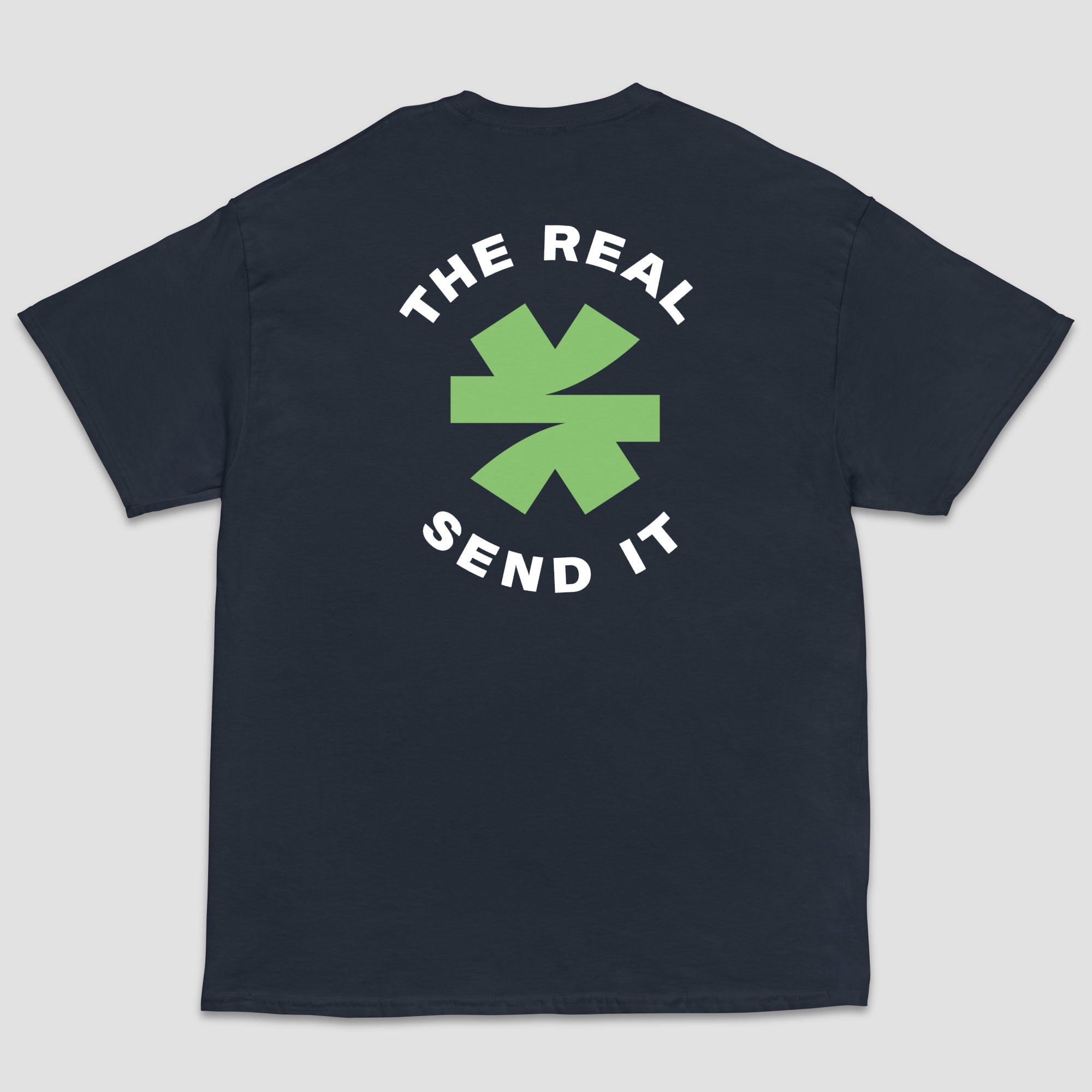 A dark navy short-sleeve t-shirt shown from the back, featuring a green and black logo with the text 'THE REAL SEND IT' centered around a green asterisk set on a light gray background.