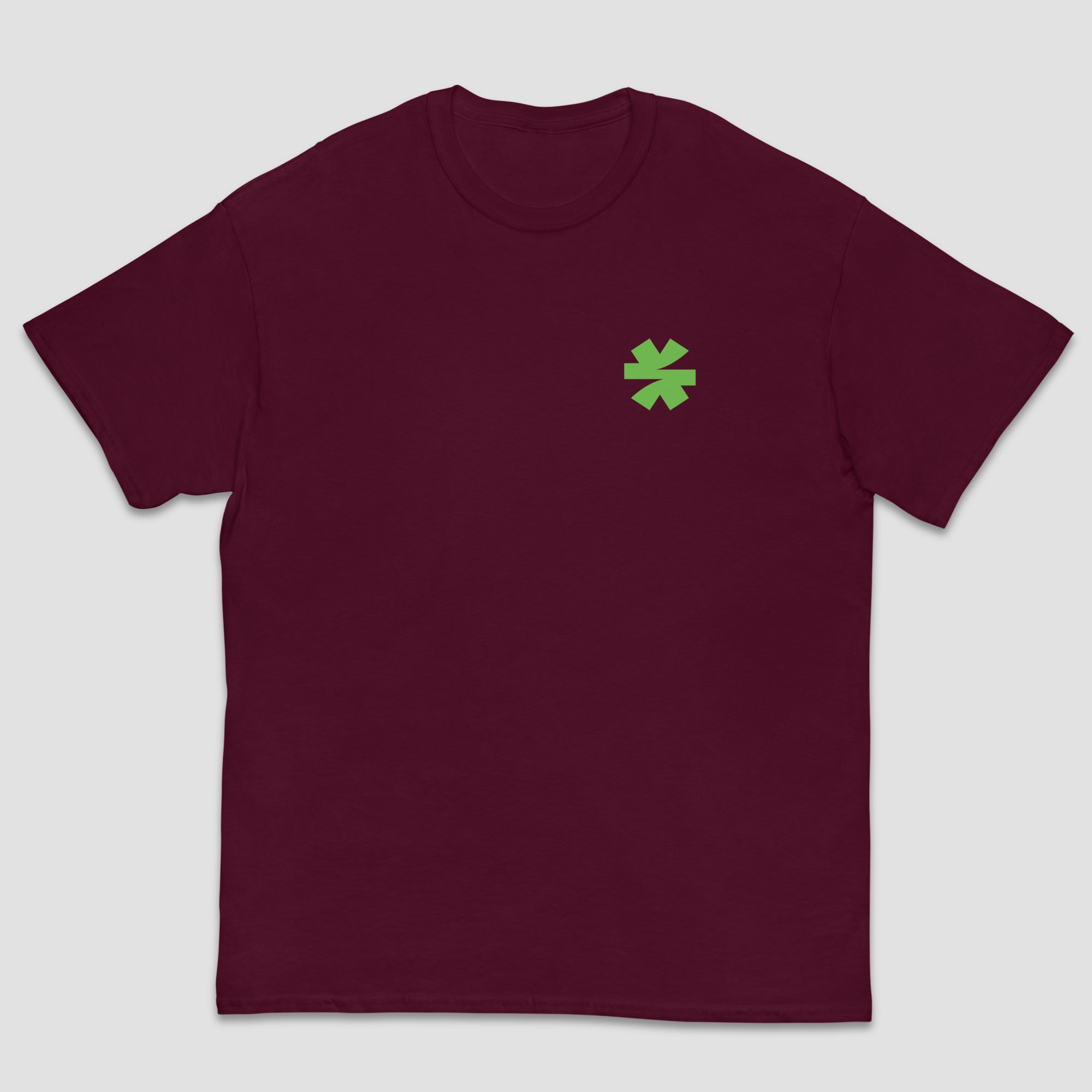 A maroon short-sleeve crewneck t-shirt with a small green asterisk on the left chest, displayed against a light gray background.