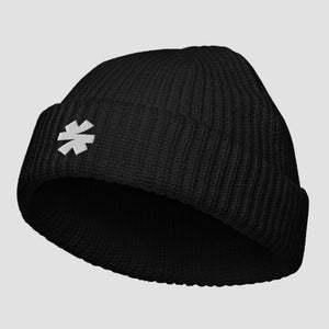 Black ribbed knit beanie with an asterisk logo on a light gray background.