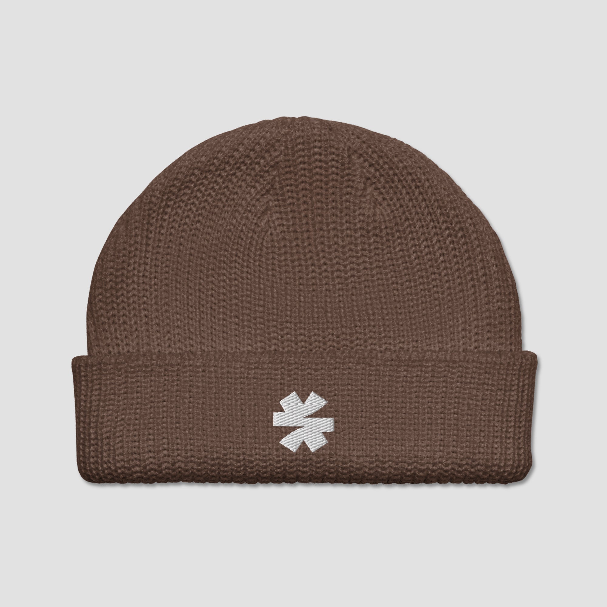 A brown ribbed knit beanie hat with a folded cuff, featuring a small white embroidered asterisk logo on the front, set against a light gray background.