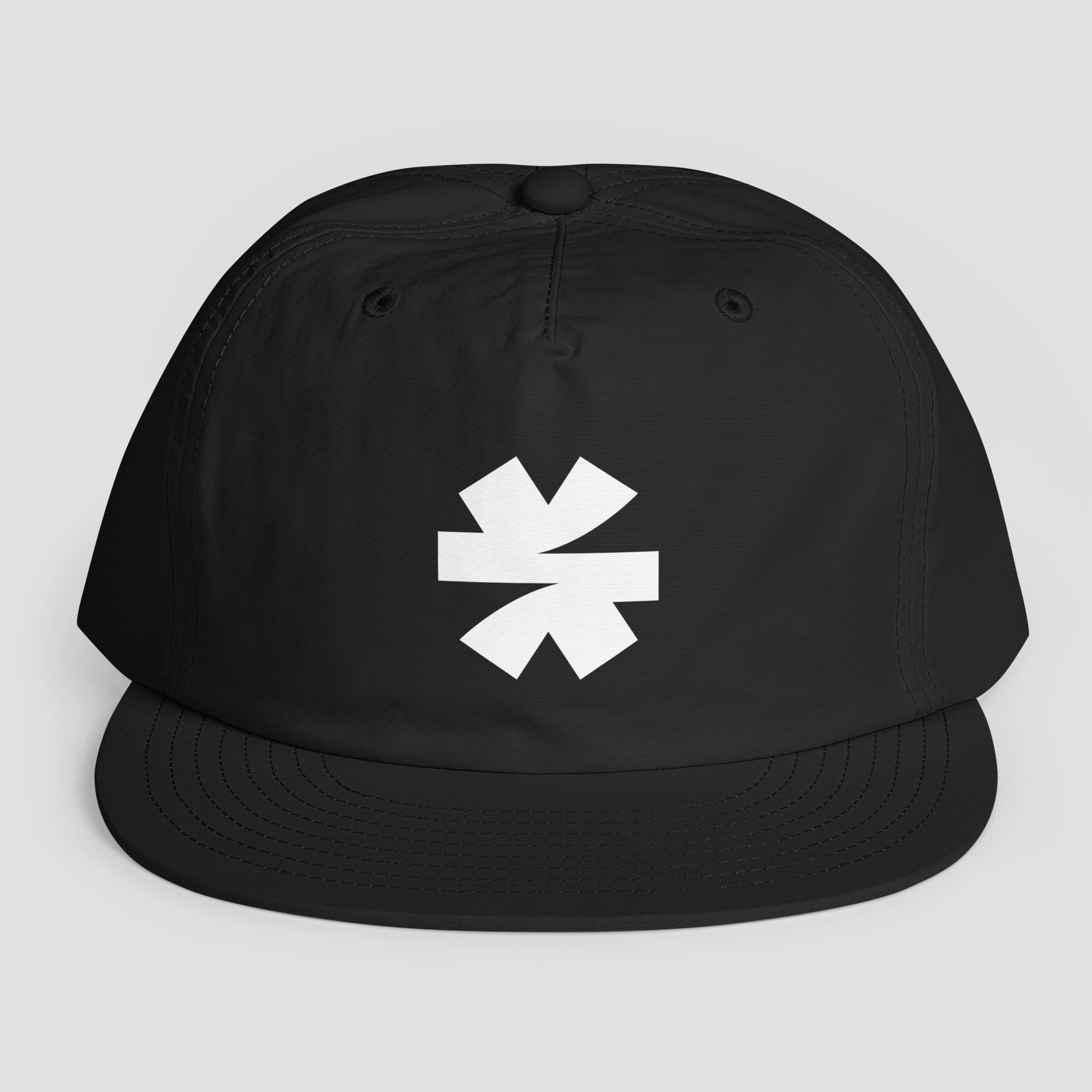 A black snapback cap with a white asterisk logo on the front, displayed against a neutral light gray background.