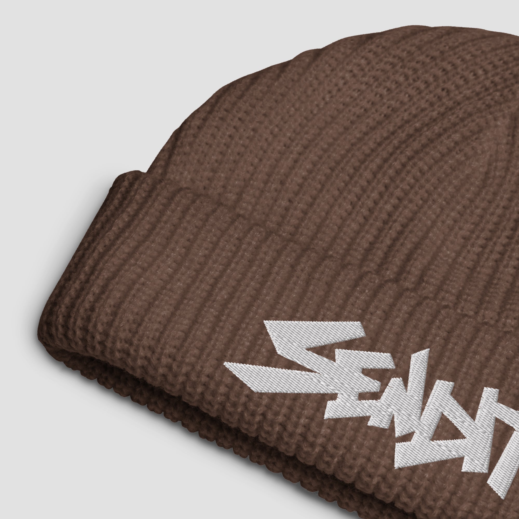 Brown beanie with 'SENDIT' text on a light gray background