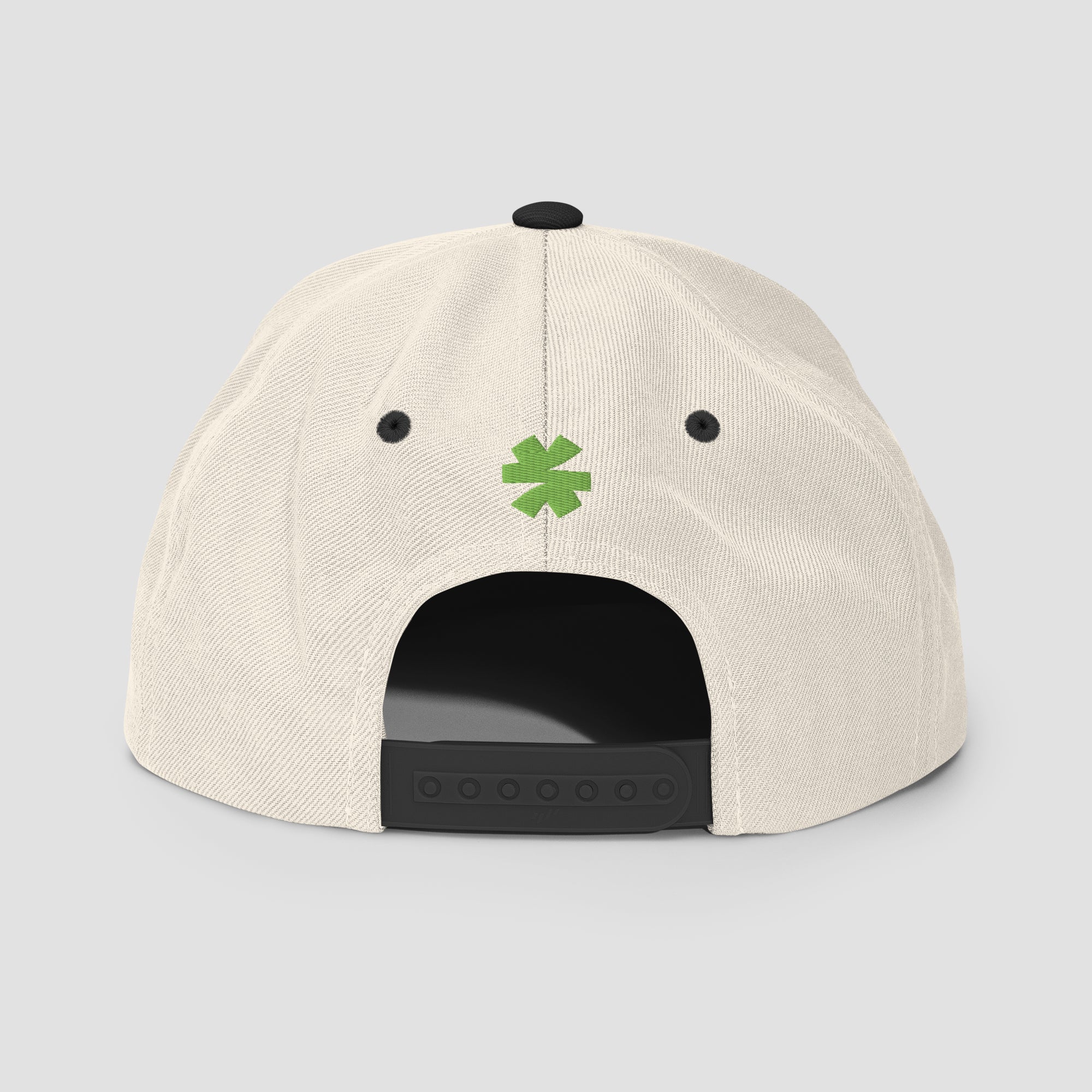 Off-white cap with black logo and trim with a small green asterisk centered on a light gray background