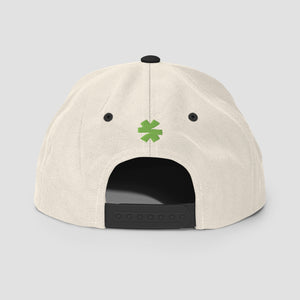 Off-white cap with black logo and trim with a small green asterisk centered on a light gray background