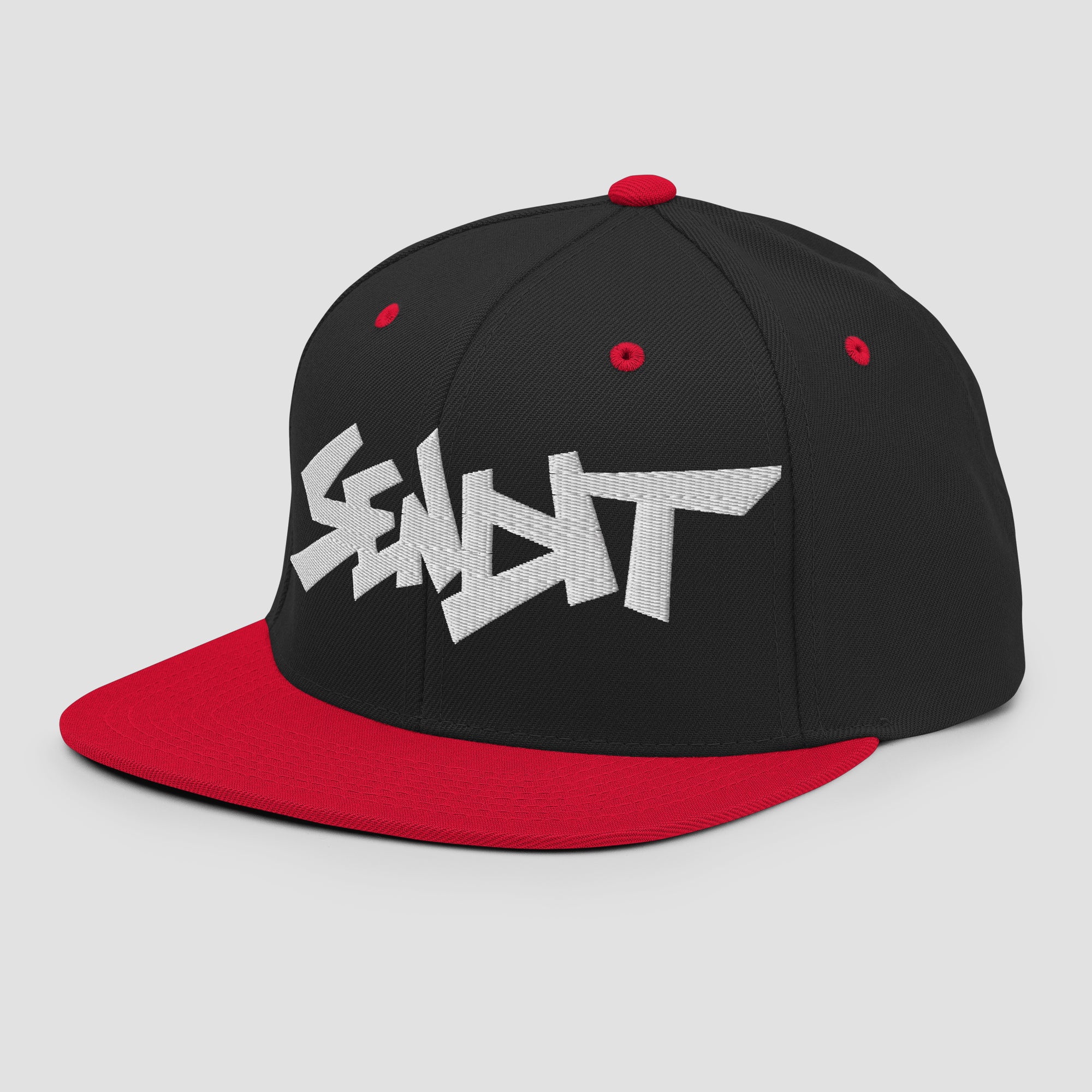 A black and red snapback cap featuring a stylized white embroidered 'SENDIT' logo on the front panel, set against a light gray background.