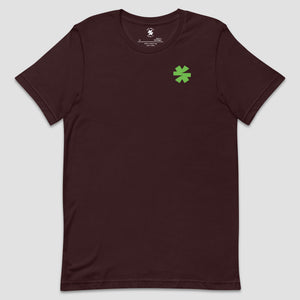 A dark maroon short-sleeve crewneck t-shirt with a small green asterisk on the left chest, displayed against a light gray background.
