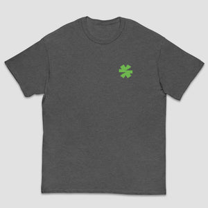 A dark heather gray crewneck t-shirt with a small green asterisk on the left chest, displayed against a light gray background.