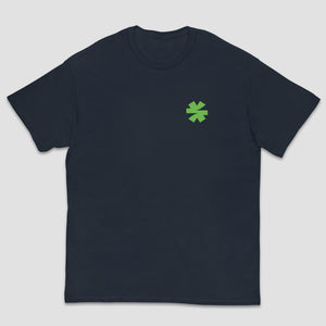 A dark navy blue short-sleeve crewneck t-shirt with a small green asterisk symbol printed on the left chest, displayed against a light gray background.